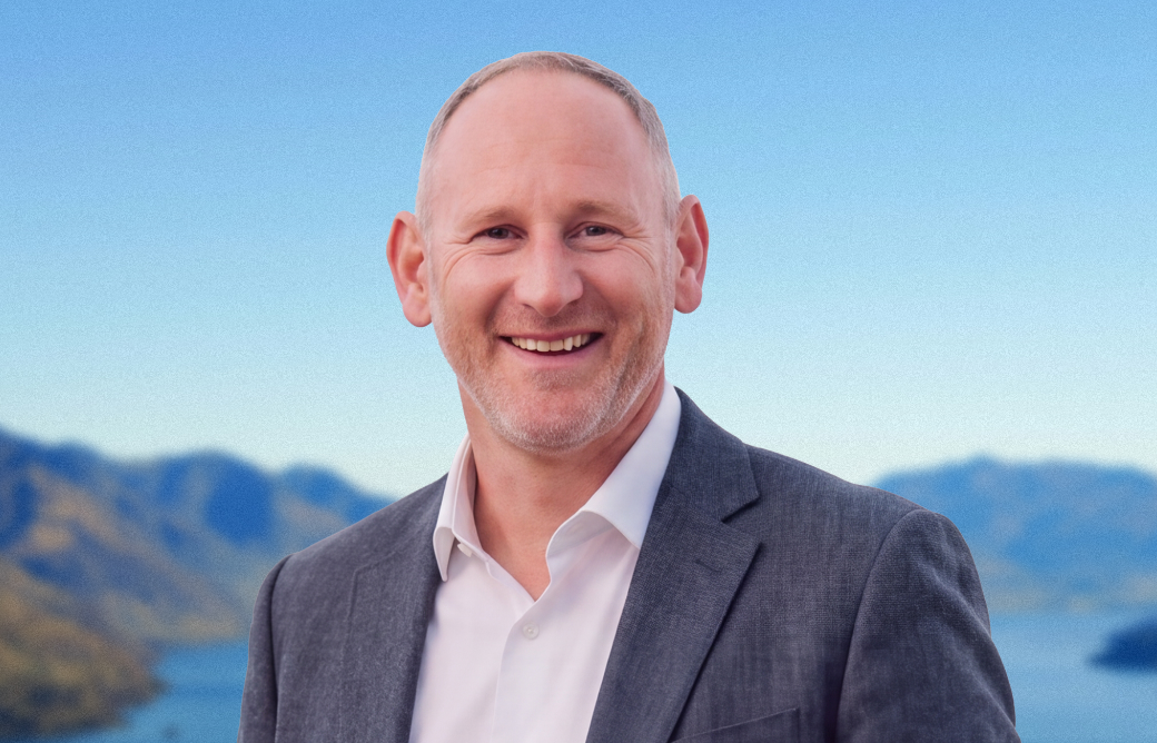 Portrait of Heath Cleland, Financial Adviser and Director at Carabiner Advice, with Lake Wakatipu behind him.